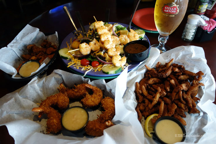 Eating Gator Bites at Ocean Deck, a beach bar in Daytona Beach, Florida