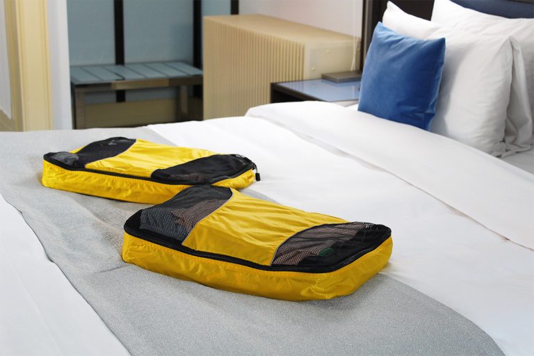 london essentials-what to pack in you're american and visiting london-packing cubes on a hotel bed